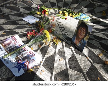 NEW YORK CITY - OCTOBER 10: Flowers And Memorbilia Are Laid Around John Lennon's Memorial At Central Park's Strawberry Fields On October 10, 2010 In New York City.