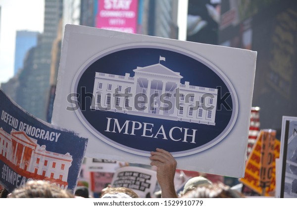 New York City, October 13, 2019: Rally\
calling for impeachment proceedings against President Trump in\
Times Square in Midtown Manhattan.\
