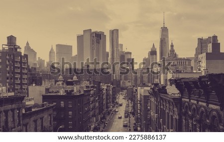 New York City overhead view of Madison Street in Chinatown and the downtown skyline buildings with a faded sepia color effect