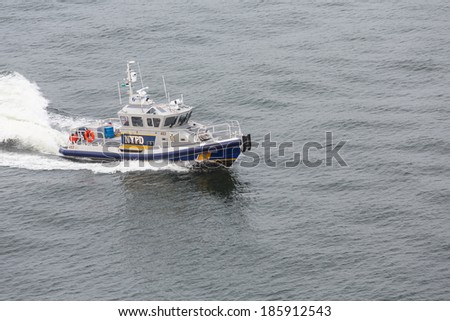 A New York City Police Boat Speeding Across the Harbor