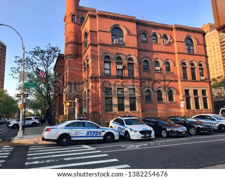 New York City Police Department 88th Precint, Brooklyn - Police station at the corner of Classon Avenue and Dekalb Avenue with several police interceptors parked in front of the building - NYC, USA