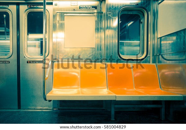 New York City seats on empty subway train car with\
vintage tone filter 
