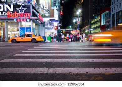 NEW YORK CITY - SEPT 13: Busy Manhattan Crosswalk At 34th St. On Night Of Sept 13, 2012. This Major Street Is Home To The Empire State Building, Penn Station And Macy's Herald Square.