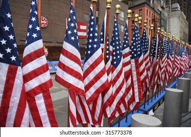 NEW YORK CITY - SEPTEMBER 11 2015: Memorial Services Were Held At Ground Zero To Mark The 14th Anniversary Of The World Trade Center Attacks. US Flags Arrayed Before Memorial Wall