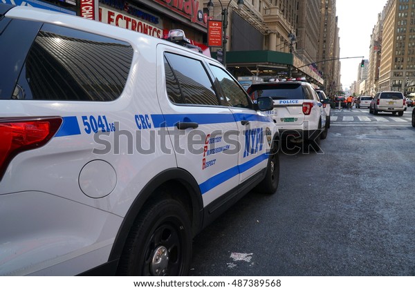 New York City - September 2016: NYPD cruiser\
patrol cars along side a Manhattan avenue. Police Department\
officers protect and serve the people to ensure safety from\
criminals and terrorist\
threats.