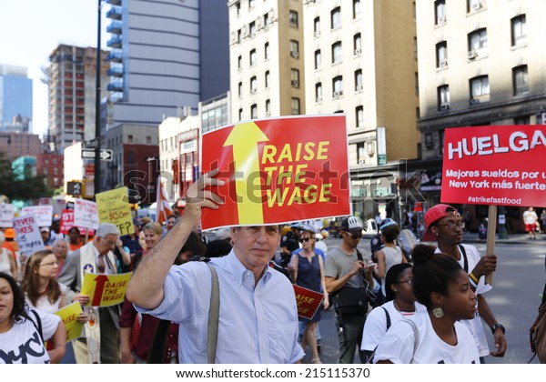 NEW YORK CITY - SEPTEMBER 4 2014: fast food\
workers and their supporters marched along 8th Ave calling for an\
increase in the minimum wage.Some attempted to block the street\
leading to several arrests
