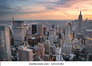 New York City skyline aerial view at sunset with colorful cloud and skyscrapers of midtown Manhattan.