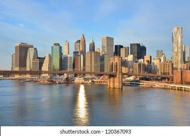 New York City Skyline With Brooklyn Bridge And Lower Manhattan View In Early Morning Sun Light