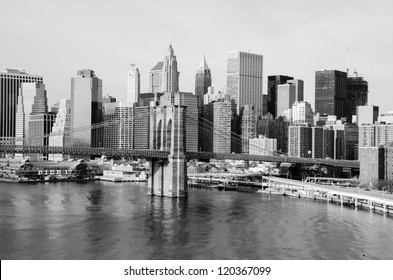 New York City Skyline With Brooklyn Bridge And Lower Manhattan View In Early Morning Sun Light - Black And White