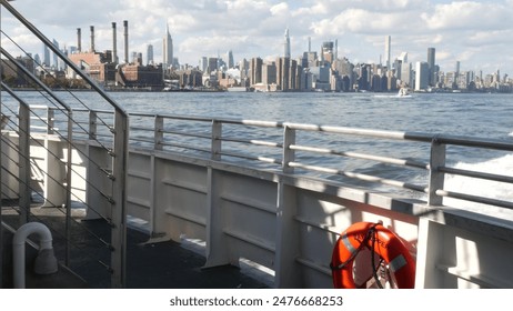New York City skyline from ferry boat. Manhattan midtown highrise skyscrapers from ferryboat. East river waterfront panorama, USA architecture. Empire State, Chrysler Building. Public safety lifebuoy. - Powered by Shutterstock