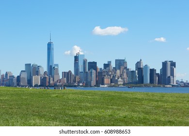 New York City Skyline And Green Meadow, Blue Sky In A Sunny Day 