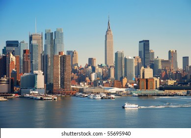 New York City skyline over Hudson river with boat and skyscraper.