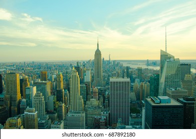 New York City skyline with urban skyscrapers at sunset. The architecture of modern city. Aerial view of Manhattan island with a soft lights and beautiful summer sky. The cultural and financial capital - Shutterstock ID 687892180