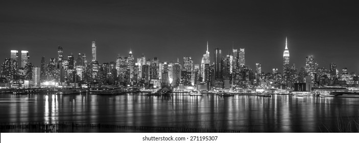 New York City with skyscrapers illuminated over Hudson River panorama - Powered by Shutterstock