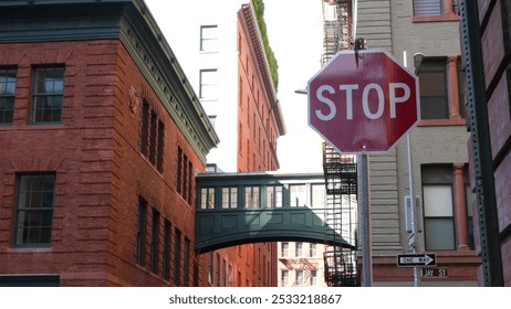 New York City Staple street skybridge. Vintage retro industrial architecture red brick building. American old historic cooper elevated sky bridge Manhattan landmark, USA. Fire escape ladder. Stop sign - Powered by Shutterstock