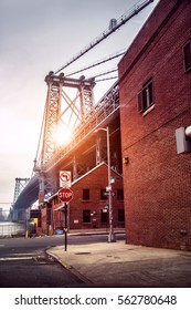 New York City Street In Brooklyn With View To Williamsburg Bridge At Sunset Time. Old Architecture Buildings.