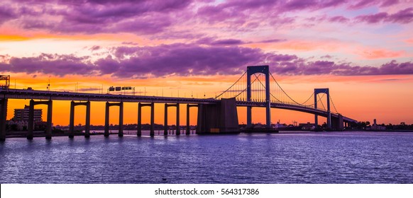 New York City Throgs Neck Bridge from Queens NYC to the Bronx with colorful sunset sky