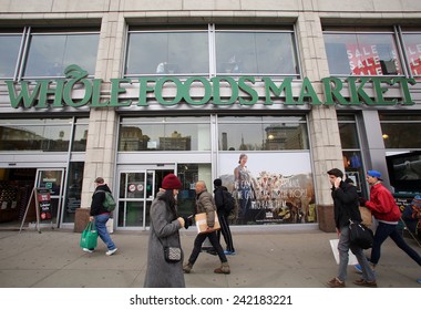 NEW YORK CITY - TUESDAY, DEC. 30, 2014: Pedestrians walk past a Whole Foods supermarket. Whole Foods Market, Inc. specializes in natural and organic foods.