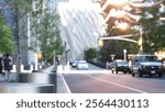 New York City, United States. Hudson Yards architecture in Chelsea, Manhattan Midtown building, NYC, USA. Defocused people, urban road car traffic, 34 street. Sunset reflection. Crossroad intersection