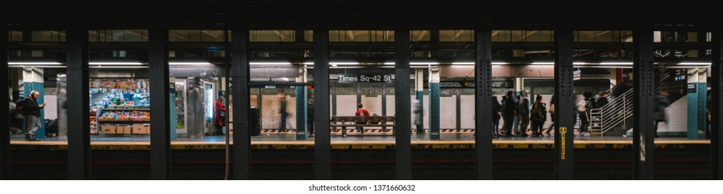 New York City, United States - Apr 4, 2019: Lifestyle of American people at Times Square subway train station platform. City life, or America underground public transportation concept. Banner size
