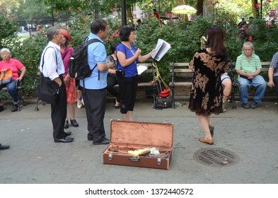 New York City, New York / United States - Circa August 2014: Female Saxophone Player Playing Music In Columbus Park