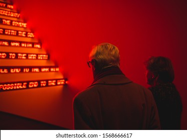 New York City, New York / United States - December 1st, 2018: An Elderly Couple Views An Installation At An Art Museum In New York City.