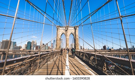 New York City, United States - Apr 1, 2019: People walk and ride bicycle on Brooklyn bridge in New York City. United states tourism landmark, American city life, or commuter transportation concept