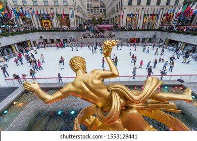 New York city, New York, USA - 10/13/2019: Seasonal ice skating rink with a golden statue at Rockefeller Center