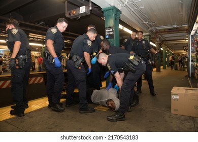 NEW YORK CITY, USA - 23 JUNE 2022: Homeless Man Blocking Subway Traffic On Rails And Trying To Escape From The Police