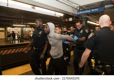 NEW YORK CITY, USA - 23 JUNE 2022: Homeless Man Blocking Subway Traffic On Rails And Trying To Escape From The Police