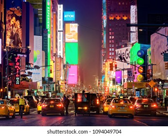 New York City, USA - April 2018: Yellow taxis and traffic at times square midtown at night - Shutterstock ID 1094049704