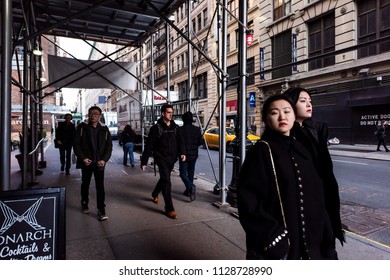 New York City, USA - April 6, 2018: Manhattan NYC Buildings Of Midtown Herald Square, Avenue Road, Signs For Monarch Bar, Many People Walking On 35th Street Sidewalk, Asian Women Under Construction 