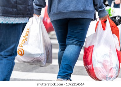New York City, USA - April 6, 2018: Manhattan NYC Sidewalk In Midtown On 6th Avenue Road And Closeup Of People Legs Walking Woman Carrying Payless And JCPenney Bag