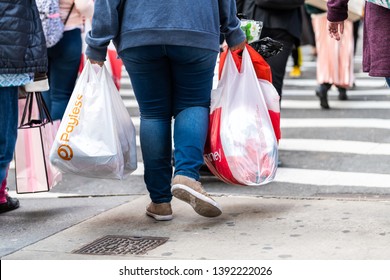 New York City, USA - April 6, 2018: Manhattan NYC Sidewalk In Midtown On 6th Avenue Road And Closeup Of People Walking Woman Carrying Payless And JCPenney Bag