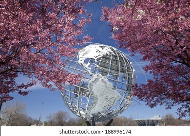 New York City, USA - April 20, 2014: The Unisphere with cherry blossom trees in Flushing Meadows Corona Park at New York City. 