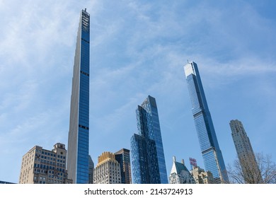 New York city, USA - April 2nd 2022: Steinway tower with Central park tower and other buildings at Manhattan.  Low angle view from central park.