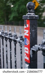 New York City, New York, USA. April 2022. Red And White FDNY Sticker On A Metal Railing Along A Side Walk In New York City. 