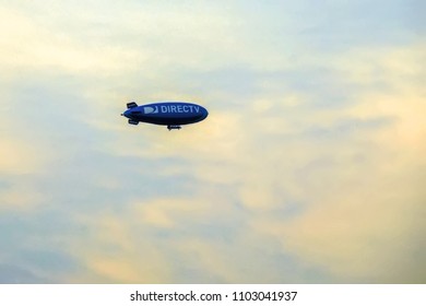 New York City, USA - August 09, 2012: Blue Dirigible With DIRECTV Logo Flying In Cloudy Sky, Overcast Skyscape With Airship