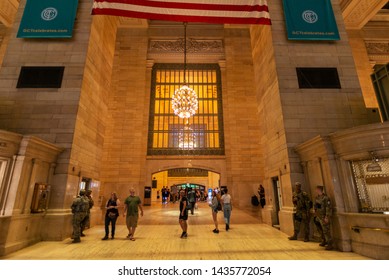 New York City, USA - August 1, 2018: Interior Of The Grand Central Terminal, Commuter Rail Terminal, With People And Soldiers Watching Located In Midtown Manhattan, New York City, USA