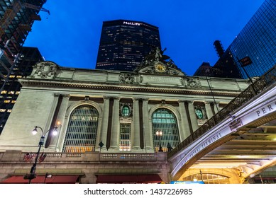 New York City, USA - August 1, 2018: Facade Of The Grand Central Terminal, Commuter Rail Terminal, At Night With The MetLife Building In The Background Located In Midtown Manhattan, New York City, USA