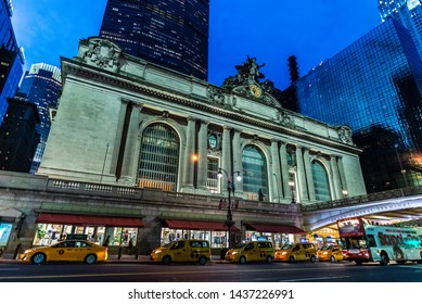 New York City, USA - August 1, 2018: Facade Of The Grand Central Terminal, Commuter Rail Terminal, At Night With People Around And A Row Of Taxis Located In Midtown Manhattan, New York City, USA