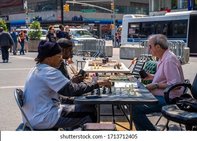 New York City, USA - August 2, 2019: Elderly People Playing Chess New Flatron Building, Midtown Manhattan, New York City, USA