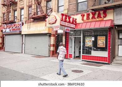 NEW YORK CITY, USA - AUGUST 16, 2015: Man Walking On A Street Of Harlem. Since 1920s, Harlem Has Been Known As A Major African American Residential, Cultural And Business Center. 