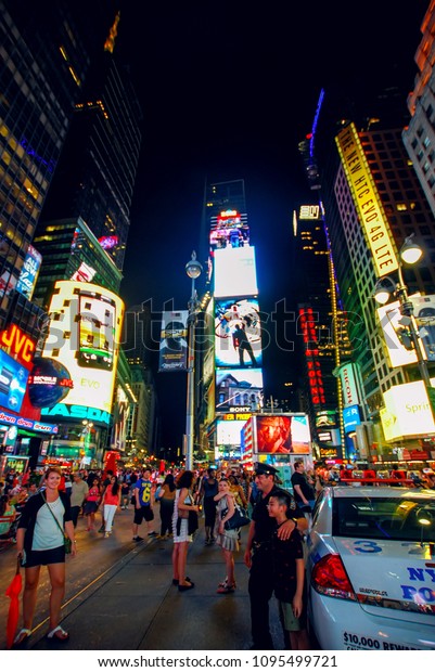 New York City, USA - August 11, 2012:\
Times Square at night. Crowds of people come from all over the\
world to Times Square in Manhattan to enjoy the\
holidays