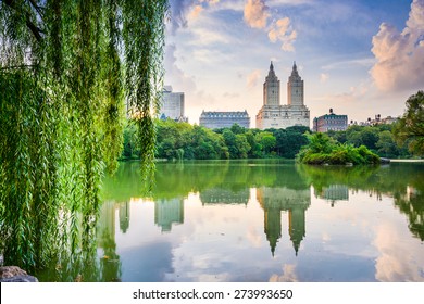 New York City, USA at the Central Park Lake and Upper West Side skyline.