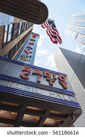 NEW YORK CITY, USA - CIRCA JUNE, 2016: A View From Underneath The Radio City Music Hall Sign And An American Flag, Located In Midtown Manhattan.