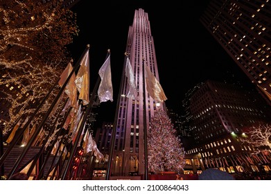 NEW YORK CITY, USA  - DECEMBER 9TH 2021: people enjoying holiday lights and Christmas Displays at Rockefeller Center and Saks Fifth Avenue. Very few are wearing facial masks despite Omicron pandemic.