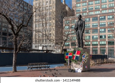 New York City, USA - Feb. 28, 2019: Statue of Juan Pablo Duarte, one of the founding fathers of the Dominican Republic, at Duarte Square, with Dominican flags and flowers