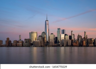 New York City - USA - Feb 17 2020: Sunset view of  Clouds Moving Over Buildings in Lower Manhattan Financial District Hudson River