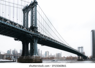 New York City, New York USA - February 11 2021: Dumbo, Manhattan bridge. Iron bridge view. Historic New York place. Brick wall buildings. Brownstone building.